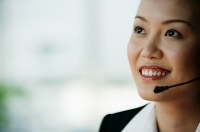 Woman wearing headset, portrait - Asia Images Group