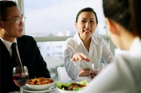 Executives having lunch, woman gesturing with hand - Asia Images Group