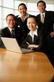 Group of executives, in boardroom, smiling at camera, portrait - Asia Images Group