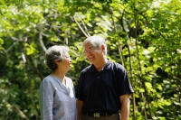 Mature couple, standing side by side, smiling, portrait - Asia Images Group