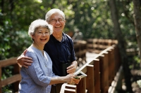 Mature couple side by side, smiling, looking at camera - Asia Images Group