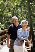 Mature couple standing, smiling, looking at camera - Asia Images Group