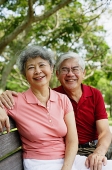 Mature couple on park bench, looking at camera - Asia Images Group