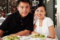 Couple at restaurant, side by side, looking at camera - Asia Images Group