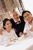 Waiter and customers at restaurant, looking at camera, portrait - Asia Images Group
