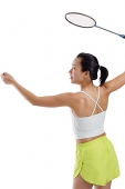 Woman holding badminton racket, about to serve - Asia Images Group