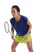 Woman holding badminton racket, looking forward - Asia Images Group