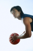 Man holding basketball, looking up - Asia Images Group