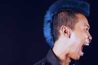 Man with mohawk, side view, mouth open - Asia Images Group