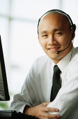 Man with headset, smiling, looking at camera - Asia Images Group