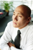 Bald executive, looking away - Asia Images Group