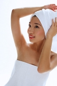 Woman wearing towel on head, looking away - Asia Images Group