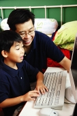 Father and son using computer - Asia Images Group
