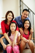 Family of four looking at camera, family portrait - Asia Images Group