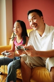 Father and daughter playing video games - Asia Images Group
