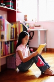 Girl sitting, reading book - Asia Images Group