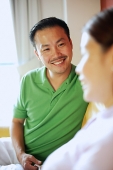 Man smiling at woman, selective focus - Asia Images Group