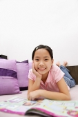 Girl lying on front, looking at camera - Asia Images Group