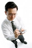 Businessman using PDA - Asia Images Group