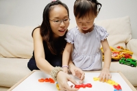 Mother and daughter, playing with toys - Asia Images Group