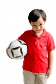 Boy smiling at camera, holding soccer ball - Asia Images Group
