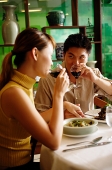 Couple in Chinese restaurant, drinking wine - Asia Images Group