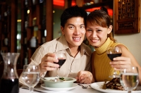Couple in restaurant, smiling at camera - Asia Images Group