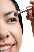 Woman applying eyeshadow, close-up - Asia Images Group