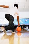 Man in bowling alley, rear view - Asia Images Group