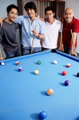 Men standing around pool table - Asia Images Group
