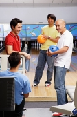 Four men in bowling alley - Asia Images Group