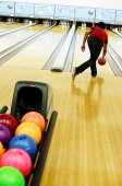 Man bowling in bowling alley - Asia Images Group