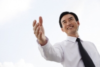 Businessman with hand outstretched - Asia Images Group