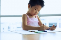 Young girl drawing with crayons - Asia Images Group