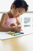 Young girl with crayons, drawing - Asia Images Group