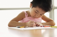 Young girl drawing using crayons - Asia Images Group
