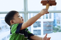 Young boy playing with toy airplane - Asia Images Group