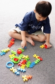 Young boy playing with building block toys - Asia Images Group