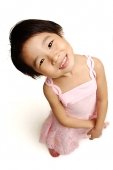 Young girl in pink dress, looking at camera, high angle view - Asia Images Group