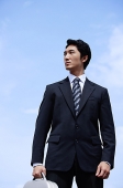 Businessman with briefcase, looking away - Asia Images Group