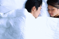 Couple sleeping on bed - Asia Images Group