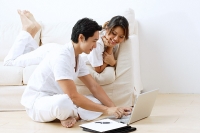 Couple at home, using laptop - Asia Images Group