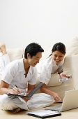Couple at home, doing home finances - Asia Images Group