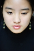 Young woman with downwards gaze, head shot - Asia Images Group