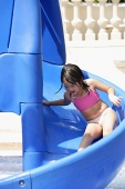 Girl playing on water slide - Asia Images Group