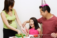 Family with one child celebrating a birthday - Asia Images Group