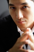 Man looking at camera, selective focus - Asia Images Group