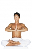 Man practicing yoga, hands together - Asia Images Group