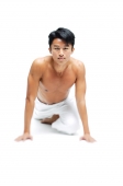 Man doing yoga, looking at camera - Asia Images Group