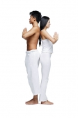 Couple doing yoga position, standing back to back - Asia Images Group